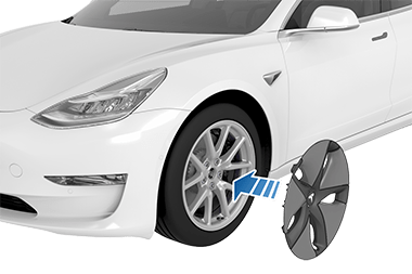 Aero cover's Tesla "T" aligned with tire's valve stem with an arrow pointing from the cover to the tire